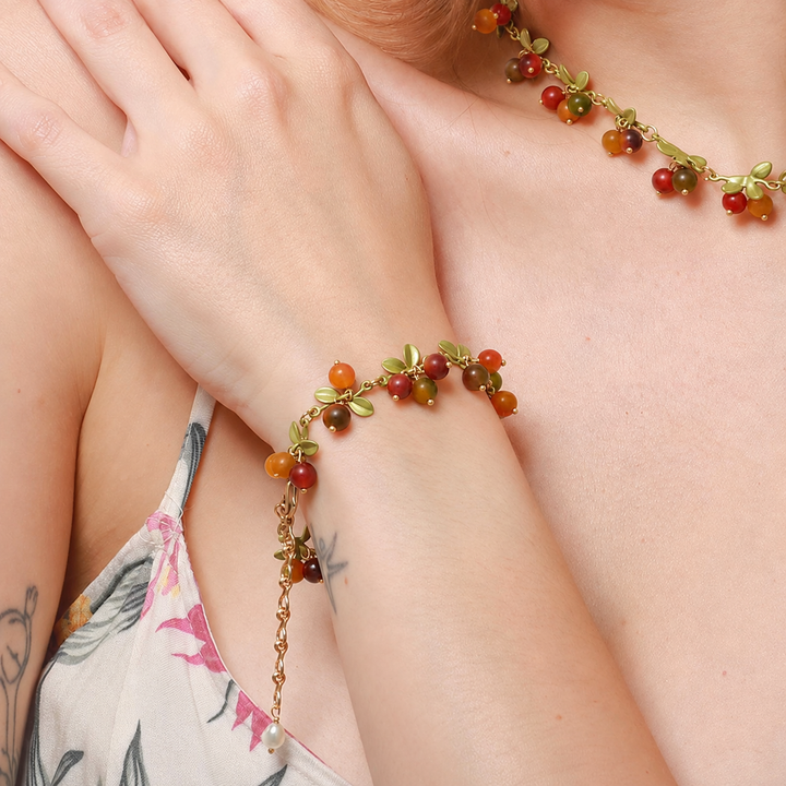 Selenichast Berry Bracelet Styled on Wrist with Floral Dress
