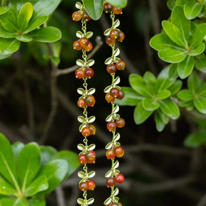 Selenichast Berry Necklace Hanging Among Fresh Green Leaves